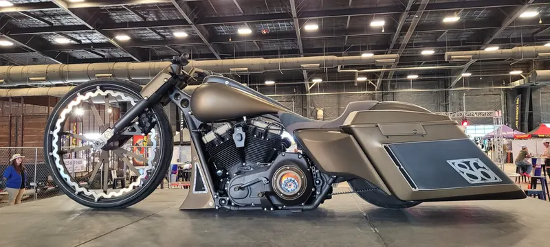 Tan custom bagger with an oversized front wheel at the Arizona Bike Week 2024 bike show