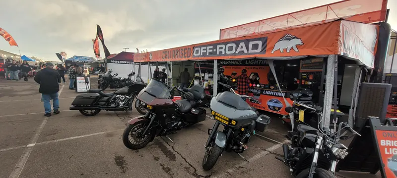 Touring motorcycles with auxiliary lights at a vendor booth at Arizona Bike Week 2024