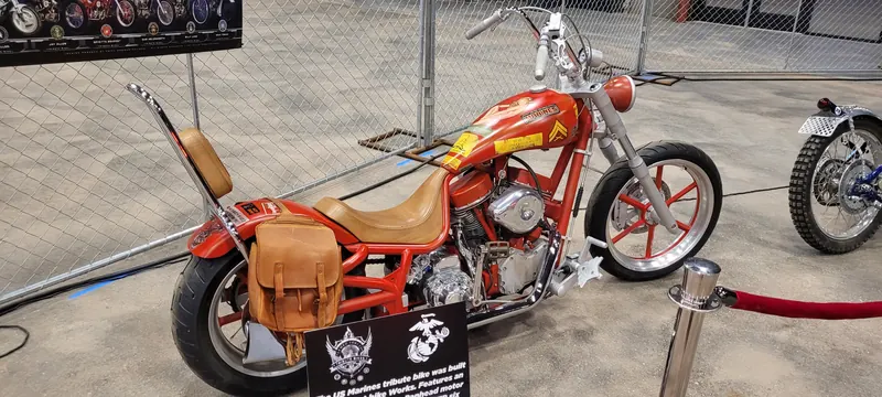 Red and gold US Marines tribute chopper with leather saddlebag at Arizona Bike Week 2024