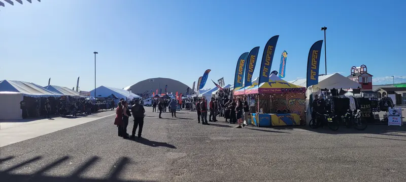 Riders walking the vendor midway on a sunny afternoon at Arizona Bike Week 2024